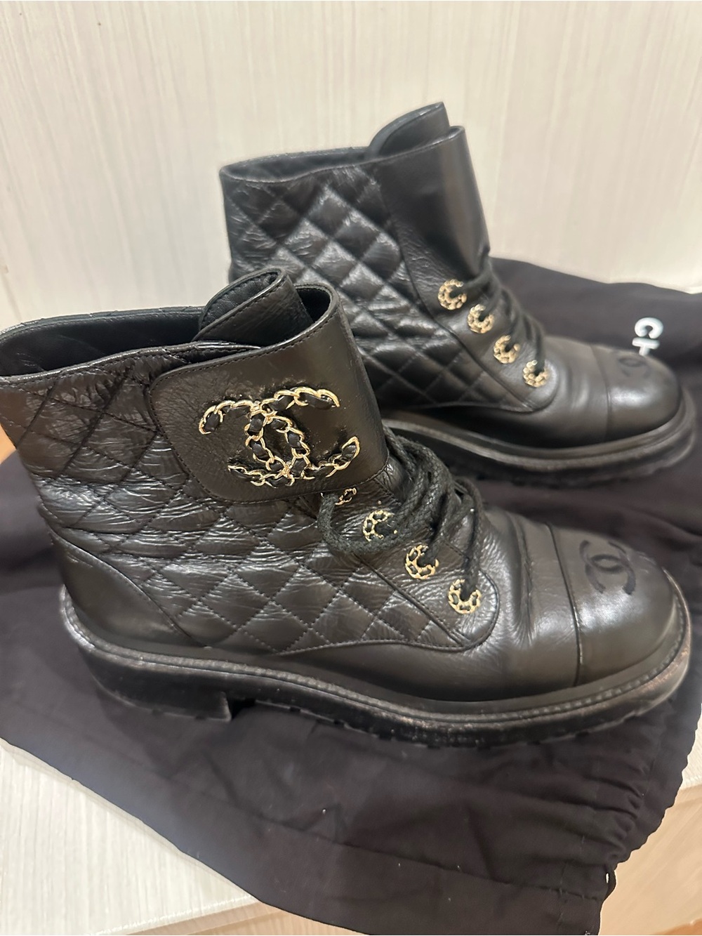 CHANEL Black Quilted Leather Combat Boots with Gold CC Accents
